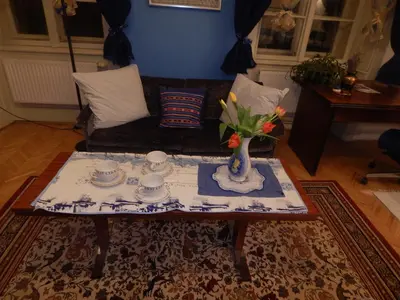 a living room with a table with a vase on it at Miraculous Appartement in Prague