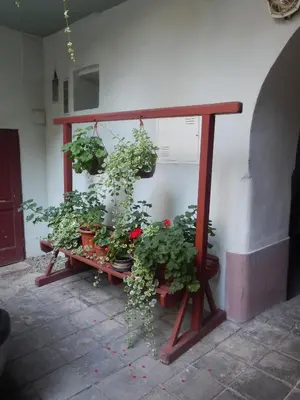 a bench with potted plants on it next to a wall at Miraculous Appartement in Prague