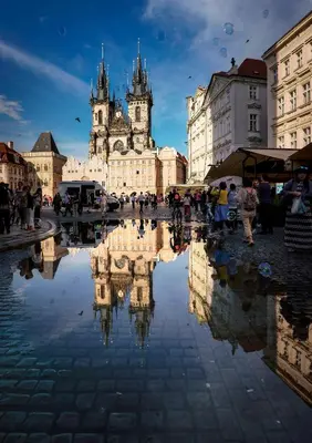 a city square with a reflection of a building at Apartments At The Blue Duckling in Prague