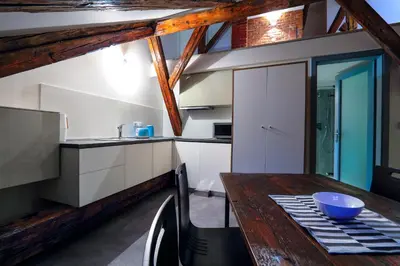 a kitchen with a wooden table with a bowl on it at Apartments At The Blue Duckling in Prague