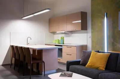 a kitchen and living room with a couch and a table at Apartments At The Blue Duckling in Prague