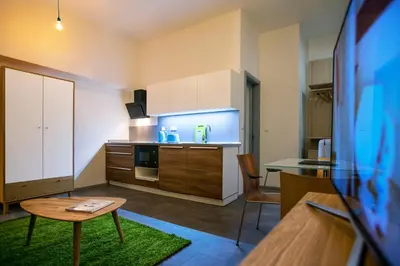 a small kitchen with a table and a counter top at Apartments At The Blue Duckling in Prague