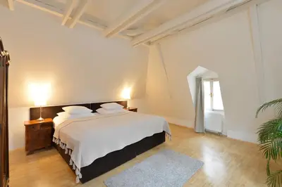 a bedroom with a white bed and a window at Eclectic Loft with Terrace in Prague