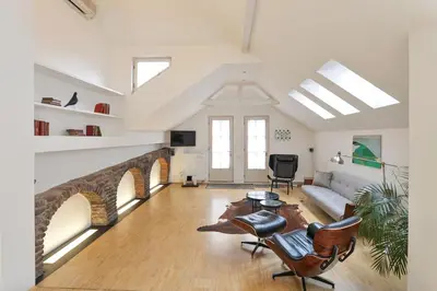 a living room with a couch and a table at Eclectic Loft with Terrace in Prague