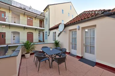 a patio with a table and chairs on a balcony at Eclectic Loft with Terrace in Prague
