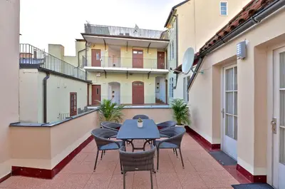 a patio with chairs and a table on a balcony at Eclectic Loft with Terrace in Prague