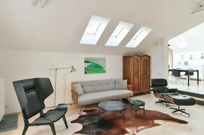 a living room with a couch and chairs and a piano at Eclectic Loft with Terrace in Prague