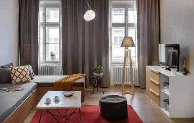a living room with a couch and a tv at 4 Trees Apartments by Adrez in Prague