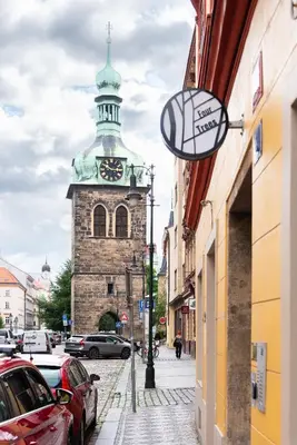 a building with a clock tower on a street at 4 Trees Apartments by Adrez in Prague