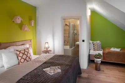 a bedroom with a bed and a green wall at 4 Trees Apartments by Adrez in Prague