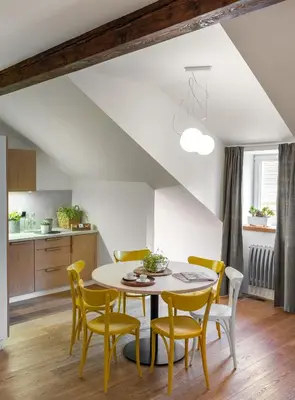 a kitchen and dining room with a table and chairs at 4 Trees Apartments by Adrez in Prague