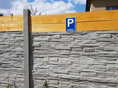 a parking sign on the side of a stone wall at Apartments Anna and Ondra in Prague