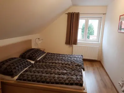 a bedroom with two beds and a window at Apartments Anna and Ondra in Prague