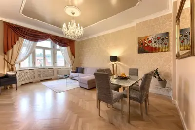 a living room with a table and a couch at Milosrdnych Apartments in Prague