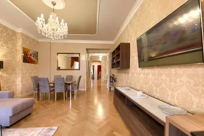 a living room with a couch and a dining room at Milosrdnych Apartments in Prague
