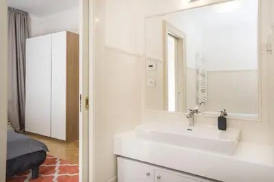 a bathroom with a white sink and a mirror at Milosrdnych Apartments in Prague