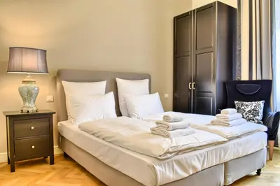 a bedroom with a bed with towels on it at Milosrdnych Apartments in Prague