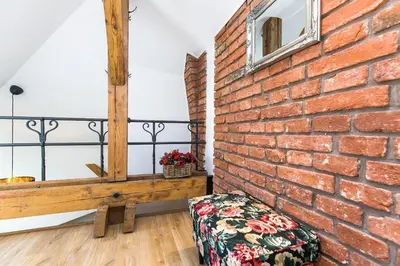 a brick wall with a bench and a window at The Old Town Square & Parizska Apartments in Prague