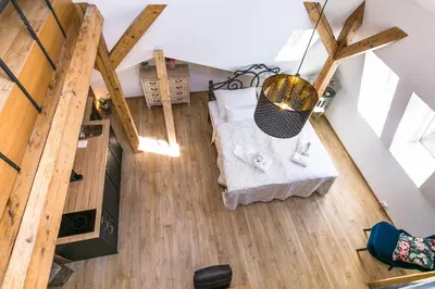 an overhead view of a room with a bed and wooden floors at The Old Town Square & Parizska Apartments in Prague