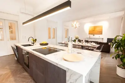 a kitchen and living room with a large island at Residence Glamour Premium in Prague