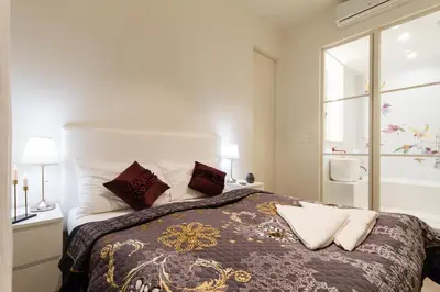 a bedroom with a large bed and a window at Residence Glamour Premium in Prague