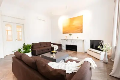 a living room with a brown couch and a fireplace at Residence Glamour Premium in Prague