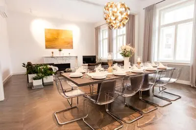 a dining room with a large table and chairs at Residence Glamour Premium in Prague
