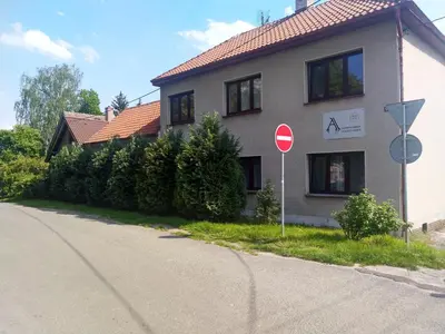 a house on the side of a street at Alisa Apartments in Kostomlaty