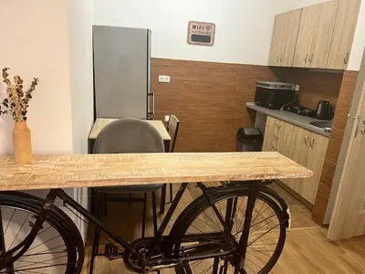 a bike parked in a kitchen with a table at Penzion Mánes in Krabčice