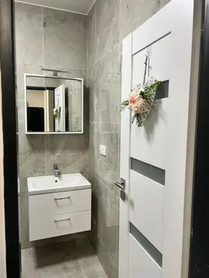 a bathroom with a white sink and a mirror at Penzion Mánes in Krabčice