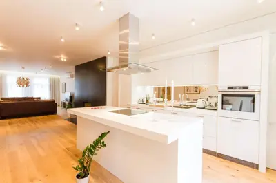 a kitchen with white cabinets and a white counter top at Residence Glamour Excellent in Prague