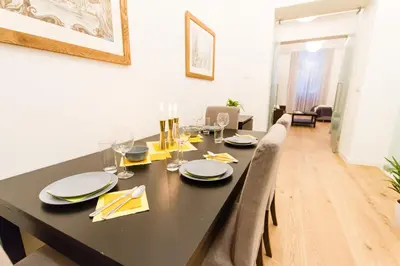 a dining room with a black table and chairs at Residence Glamour Excellent in Prague