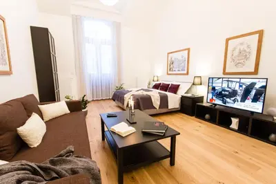a living room with a couch and a tv at Residence Glamour Excellent in Prague