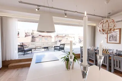 a dining room with a white table and a large window at Residence Glamour Excellent in Prague