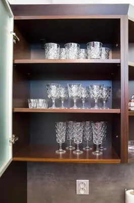 a row of glasses on a shelf in a cabinet at Luxury apartments Pricna in Prague