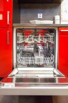 a dishwasher filled with dishes and utensils at Luxury apartments Pricna in Prague