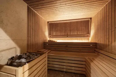 a wooden sauna with a window and a tub at Hotel Royal Prague in Prague