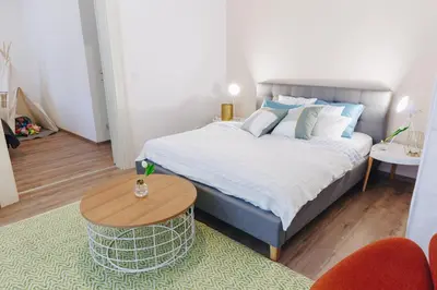 a white dining room with a white table and white chairs at Chill apartments in Prague