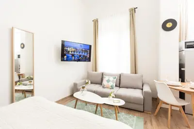a living room with a couch and a table at Chill apartments in Prague