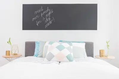 a bedroom with a bed with a poster on the wall at Chill apartments in Prague