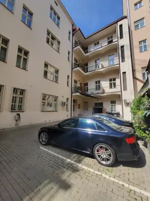 a living room with two tables and a chair at Chill apartments in Prague