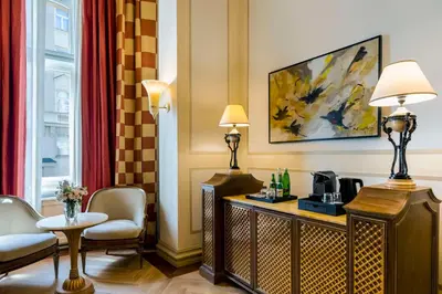 a bedroom with a bed and a desk and a window at NH Collection Prague Carlo IV in Prague