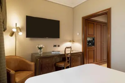 a white bath tub in a bathroom with a window at NH Collection Prague Carlo IV in Prague