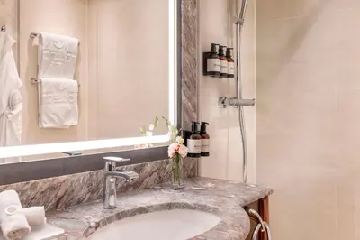a bathroom with two bottles of soap and a sink at NH Collection Prague Carlo IV in Prague