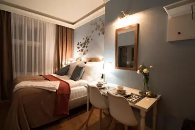 a hotel room with a bed and a table with chairs at Residence Vaclavska in Prague