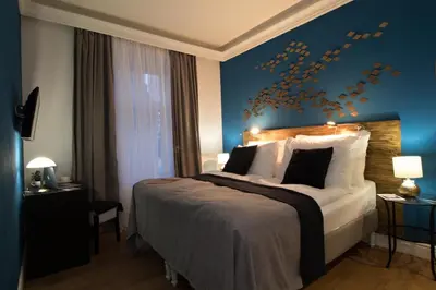 a bedroom with a large bed with a blue wall at Residence Vaclavska in Prague