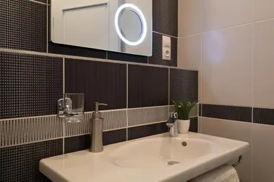a bathroom with a white sink and a mirror at Residence Vaclavska in Prague