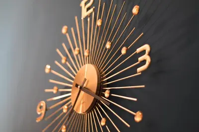 a gold sunburst clock on a black wall at Residence Vaclavska in Prague