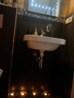 a sink in a bathroom with a mirror and lights at Imperial Rezidence in Prague