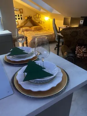 a table with two plates and wine glasses on it at Imperial Rezidence in Prague